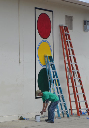 Sequoia janitor Seng Kim devoting his breaks and after-school time to paint Peace Signs murals.