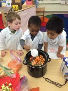 Students at Seaton Elementary prepare a meal using vegetables from the school garden.
