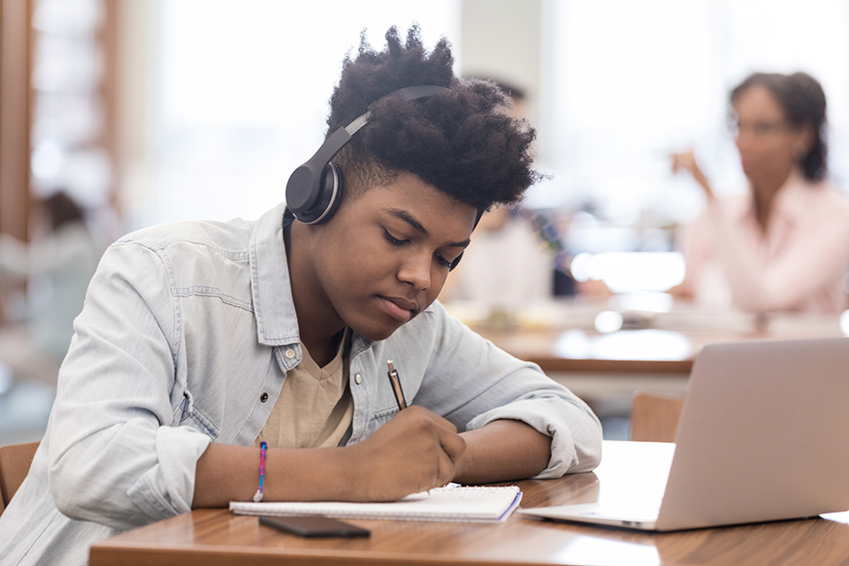 Teen listens to music while working