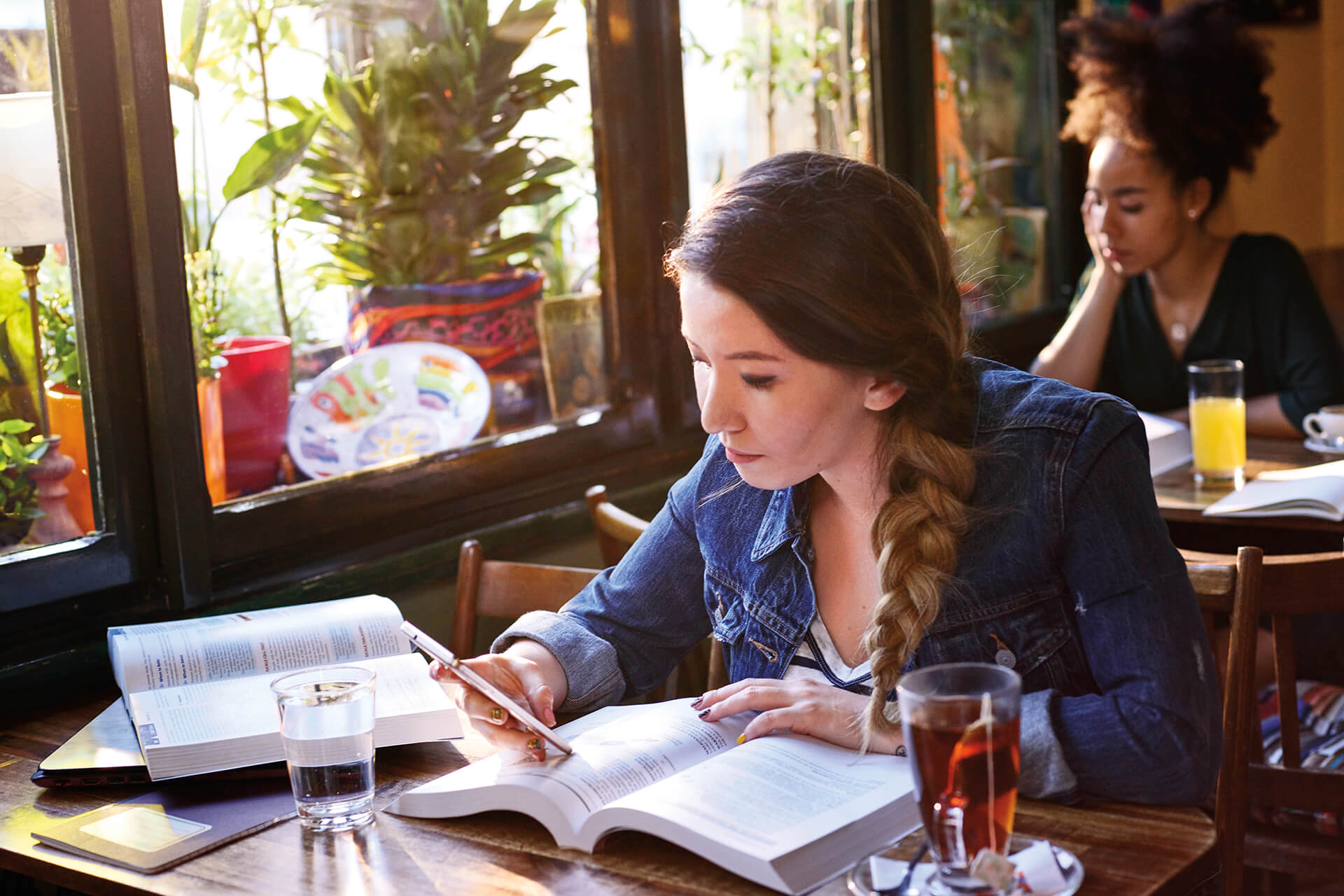 Student in cafe studying at table