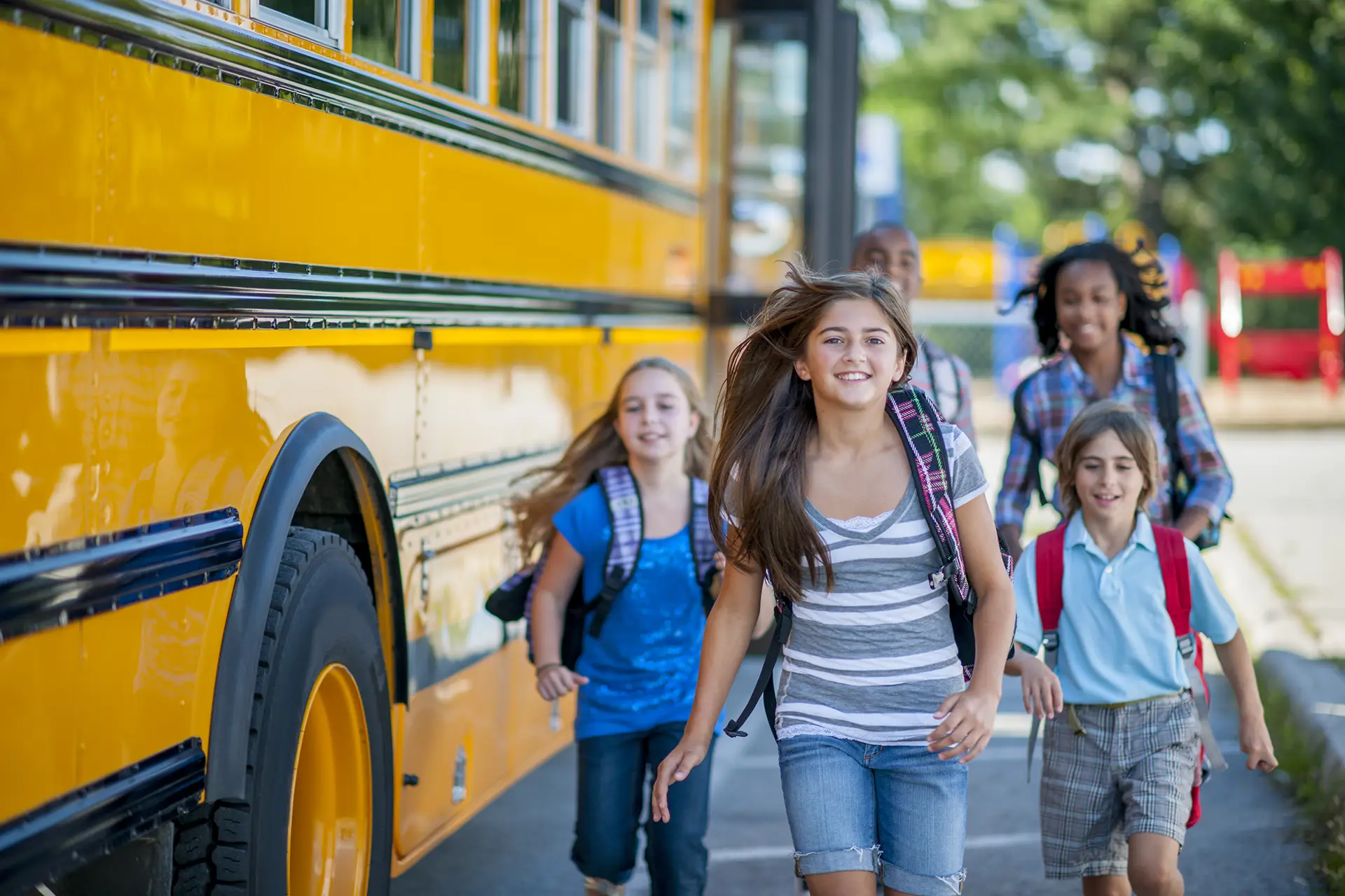 Young students getting off the school bus